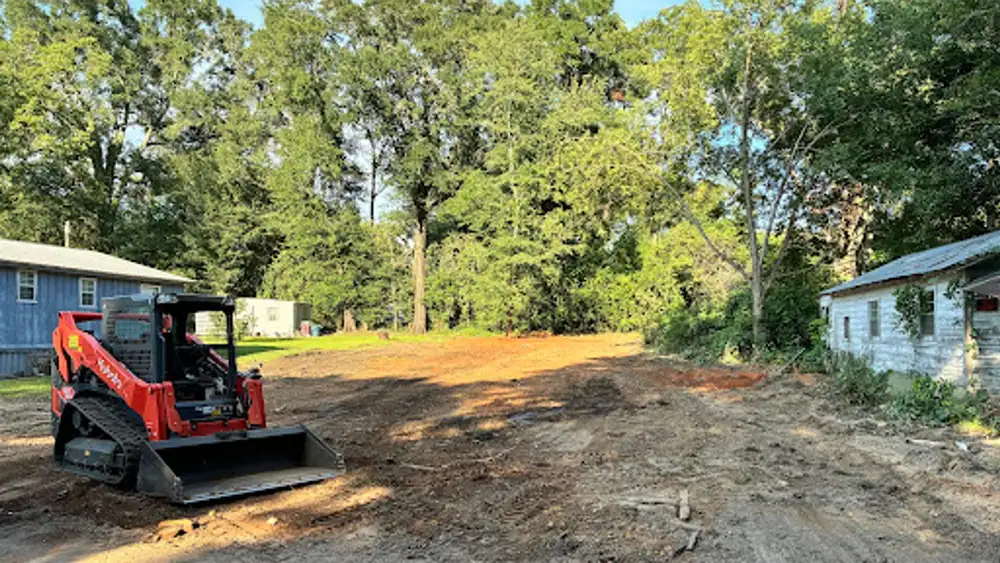 Cleared, graded lot with a Kubota track loader after a Big Cal’s teardown and clearing job