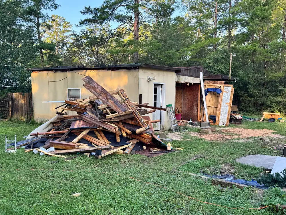 Pile of lumber from a demolished shed in a back yard