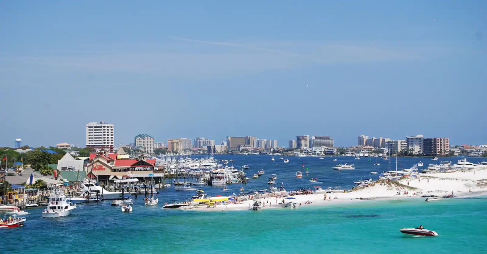 Destin Harbor with boats and the Destin skyline behind Crab Island
