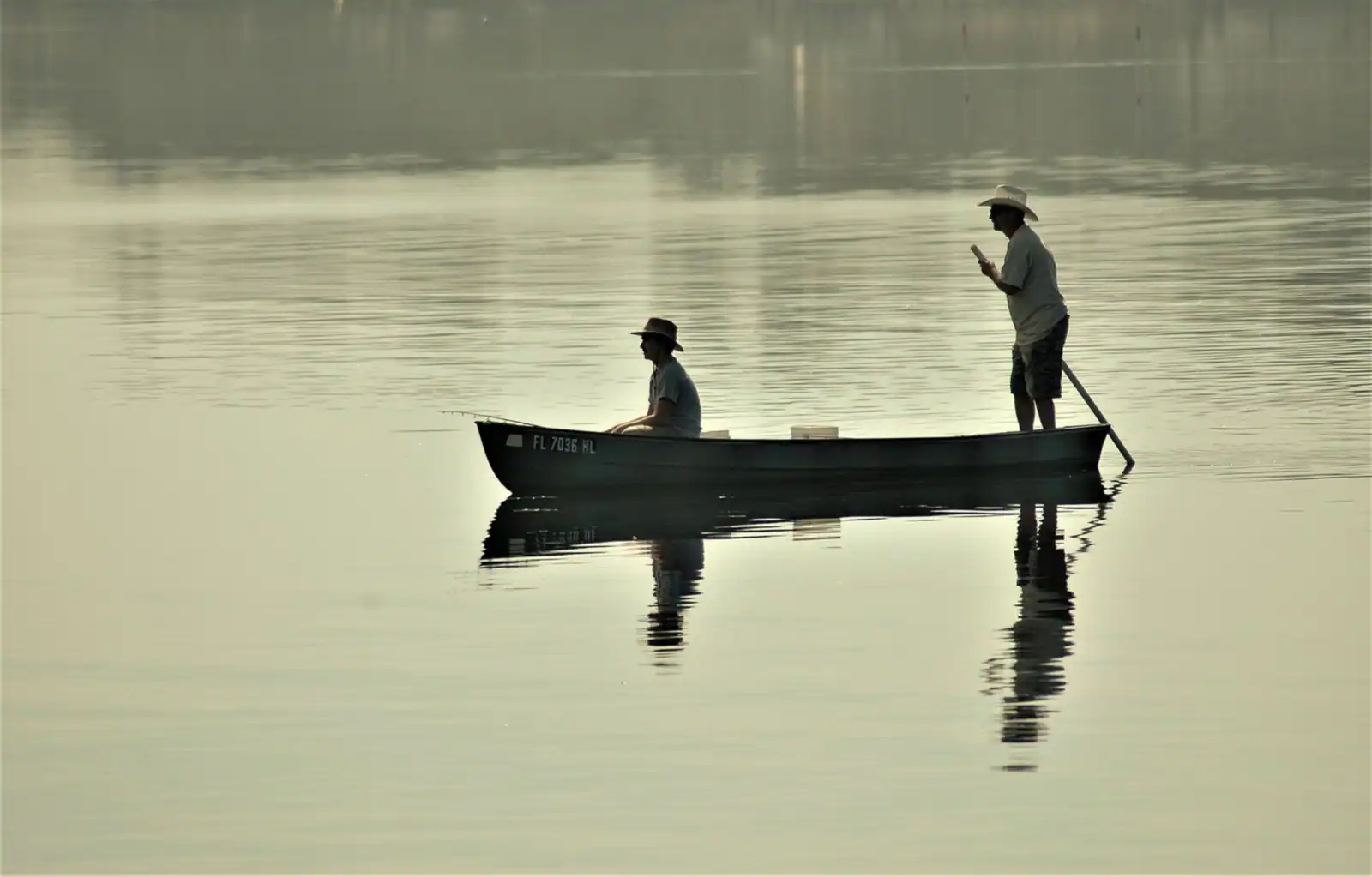 A small boat on Boggy Bayou at golden hour in Niceville, FL